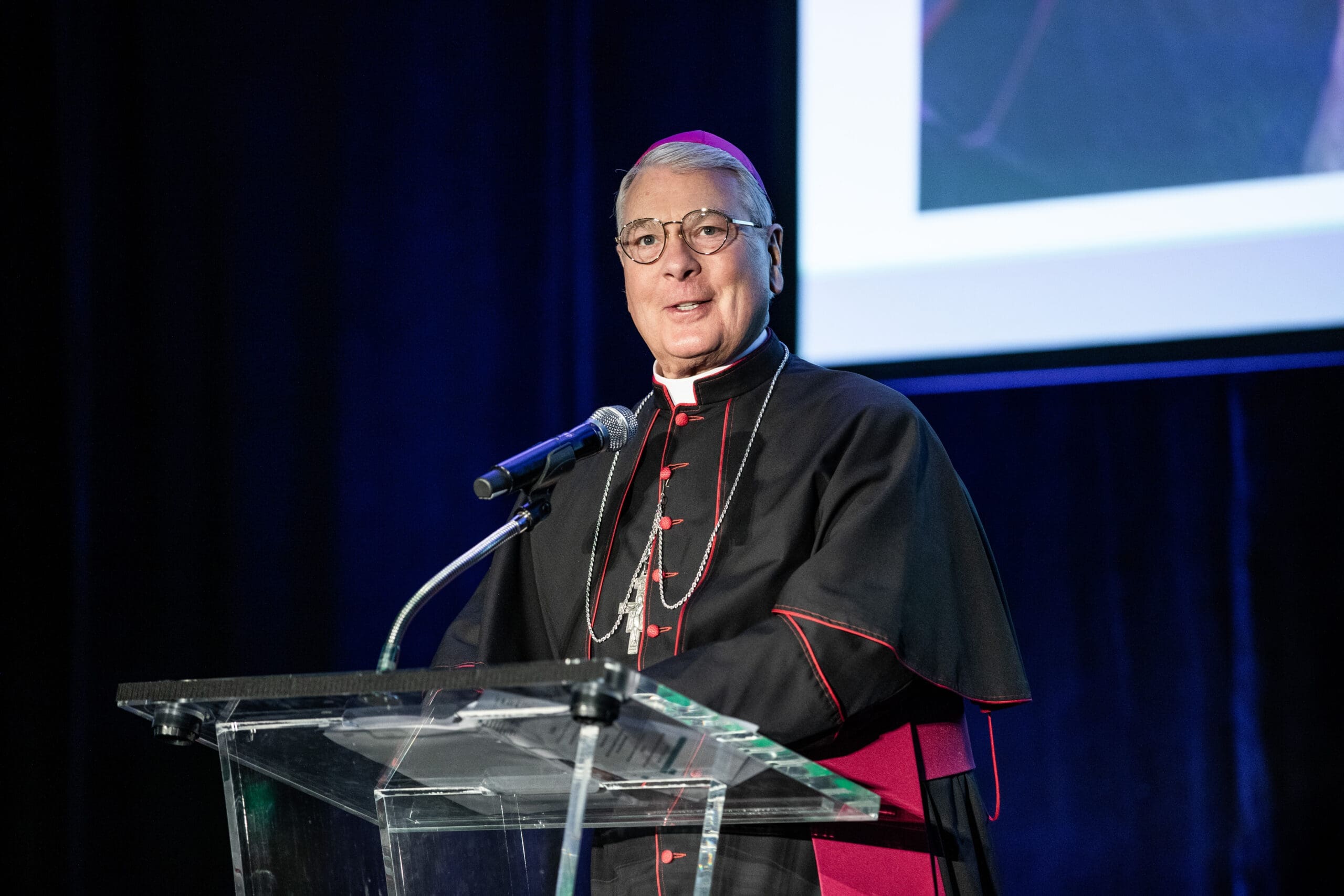 Archbishop Hartmayer standing before a Podium
